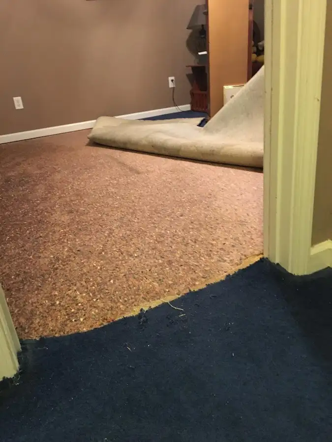 Carpet pad removal revealing water damage during Water Mitigation Services in Maricopa