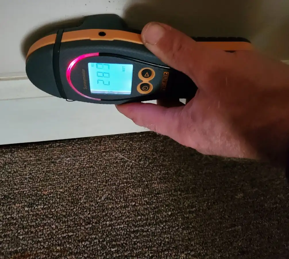 Moisture detection at baseboard during Storm Damage Restoration in Maricopa